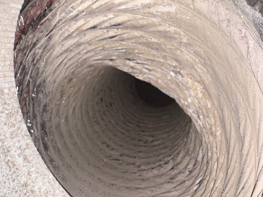 Before: dryer vent clogged with lint and debris