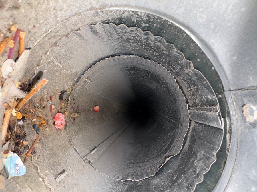 Before: dryer vent clogged with lint and debris