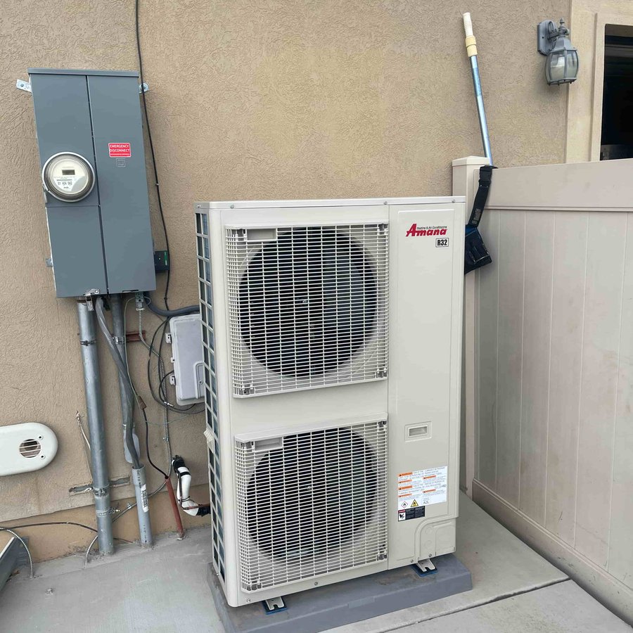 Newly installed Amana heat pump system outside a Utah home