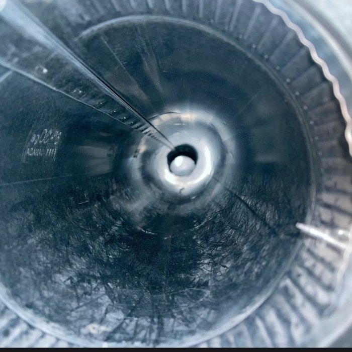 Blower wheel coated with dust and debris before a cleaning service