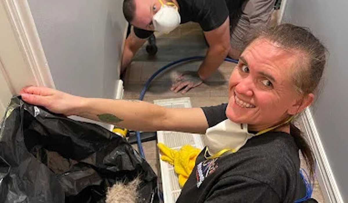 Mammoth technicians removing debris during a whole-home duct cleaning